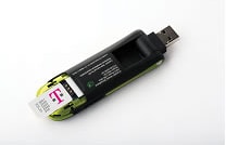 The bottom T-Mobile USB laptop stick with the SIM being inserted on the curved end of the device